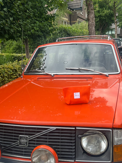 MIKAH Bright Orange Mini Pouch on bright orange car.