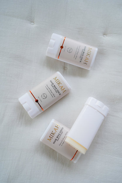 MIKAH Hair Wax Stick products arranged on a light background