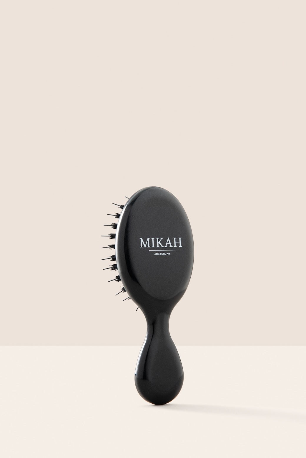 MIKAH black travel size hairbrush with compact handle