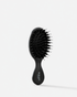 MIKAH Mini Hairbrush Black with flexible nylon bristles on a white background