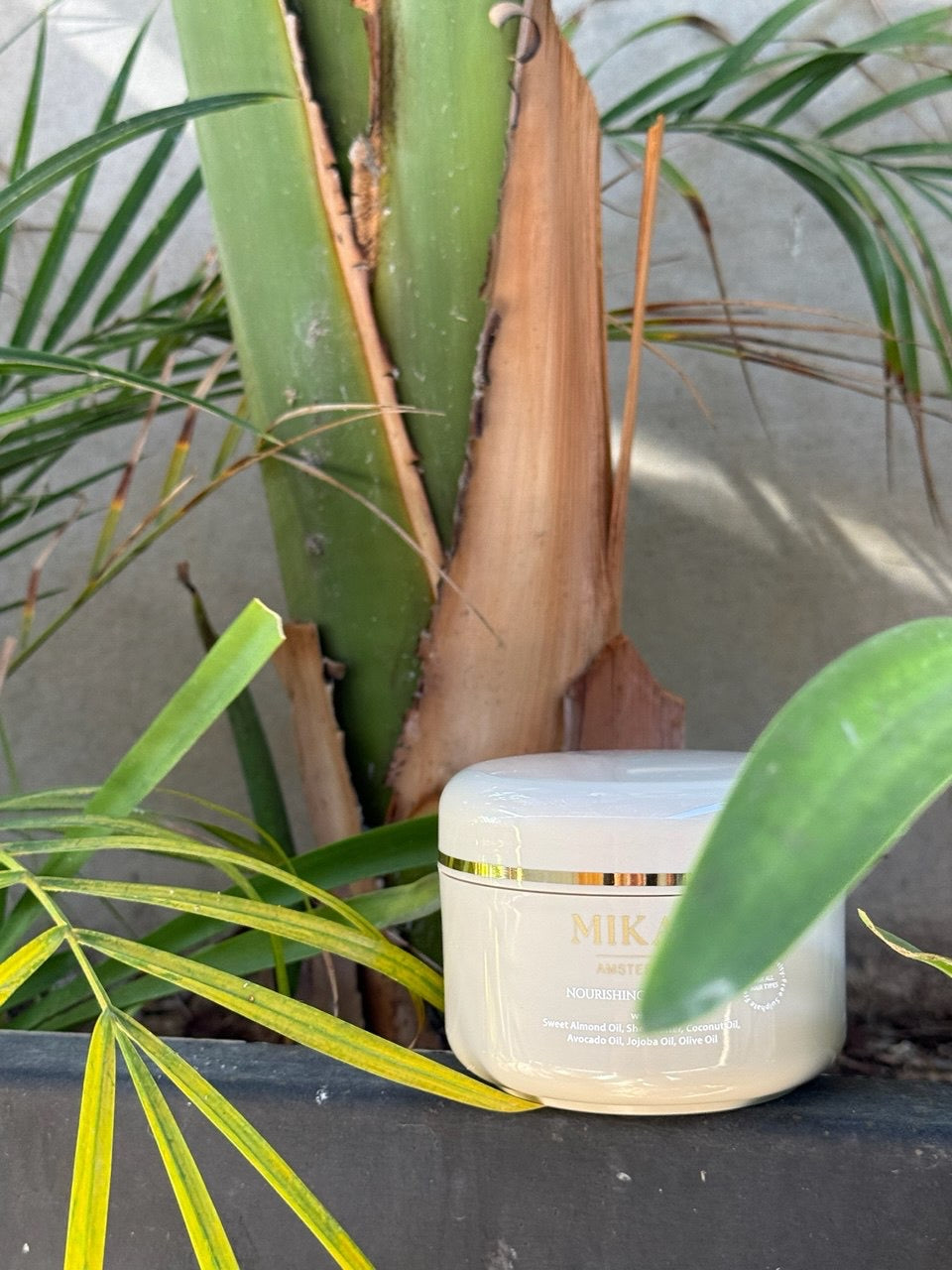 MIKAH Nourishing Hair Mask displayed with green botanical leaves