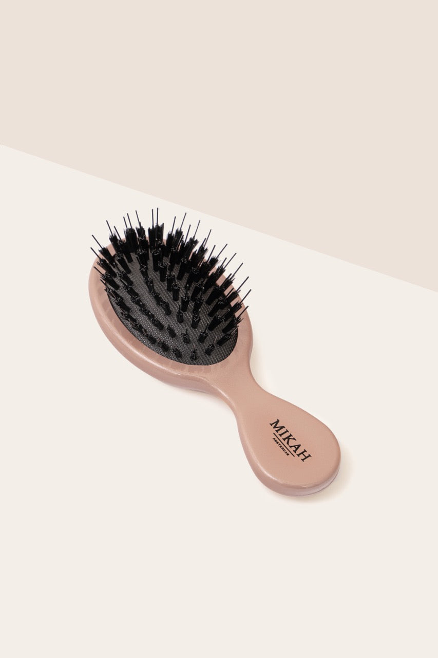 MIKAH pink travel size detangling hairbrush with nylon bristles