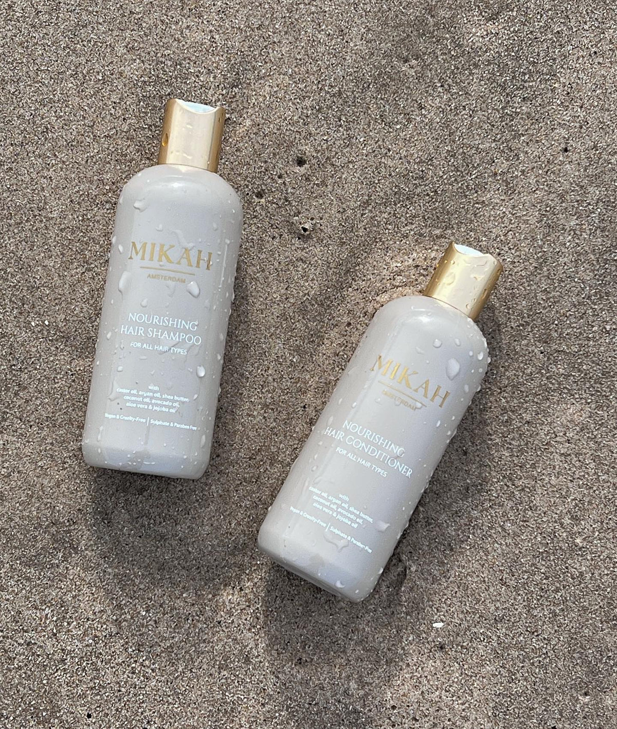 MIKAH Nourishing Haircare bottles on a textured surface