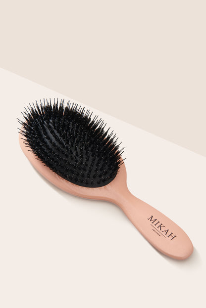 Close-up of MIKAH Paddle Hairbrush with flexible nylon bristles