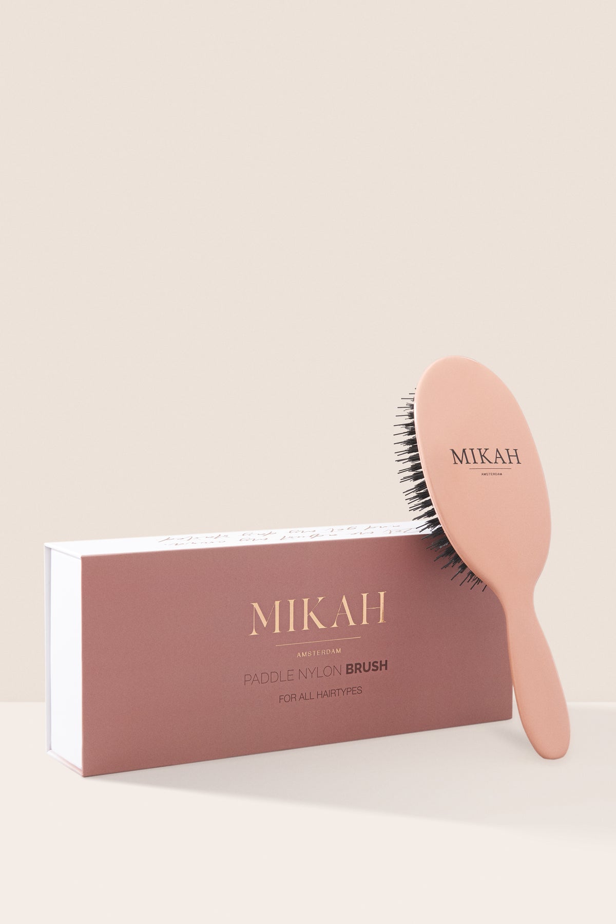 MIKAH pink nylon paddle hairbrush with product packaging